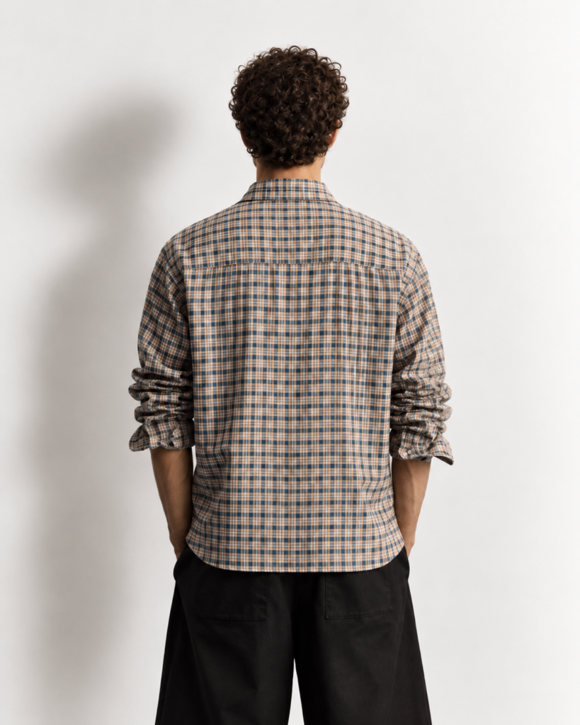 curly haired man in plaid shirt