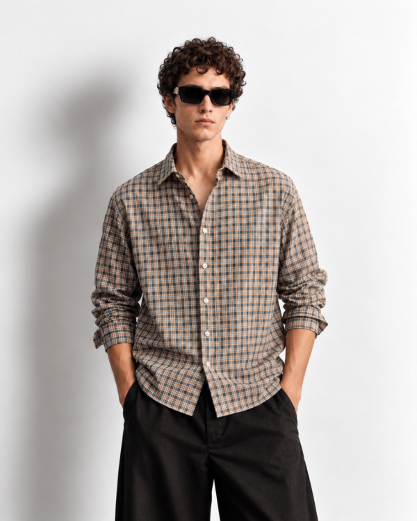 curly haired model in plaid shirt