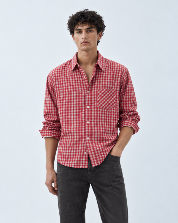editorial portrait in red plaid and dark denim